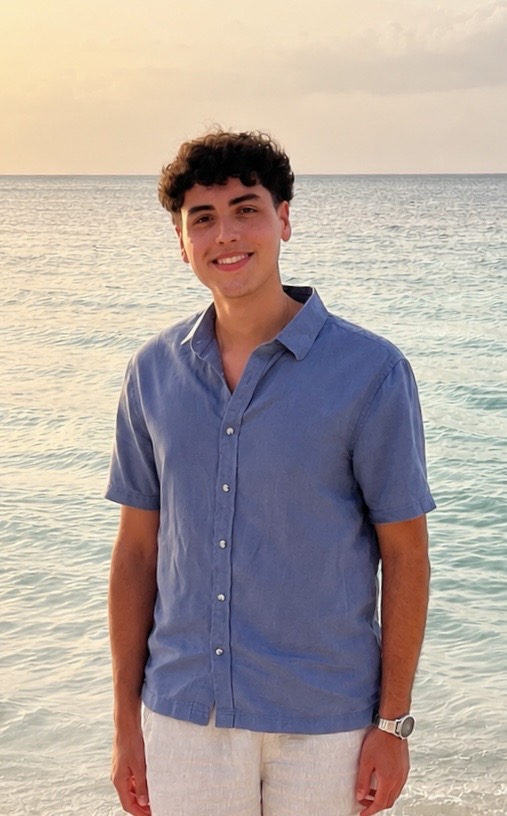 Alex Yesilyurt standing by the ocean.